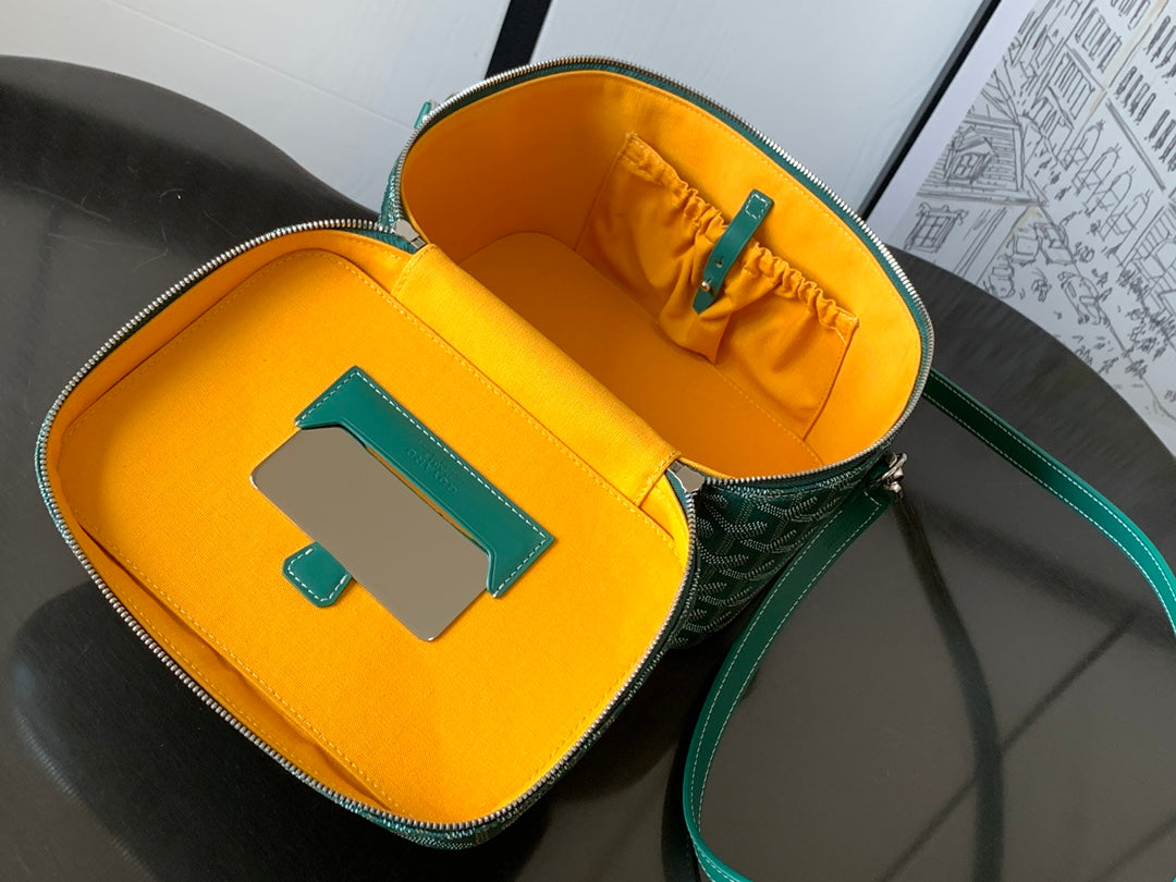 Interior view of small green bag showing bright yellow lining and zippered storage pocket