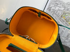 Goyard bag open interior with orange lining, front pocket and green trim