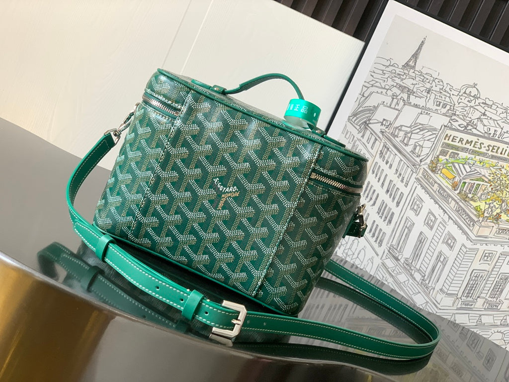 Green patterned small crossbody bag with long teal strap and top zip closure