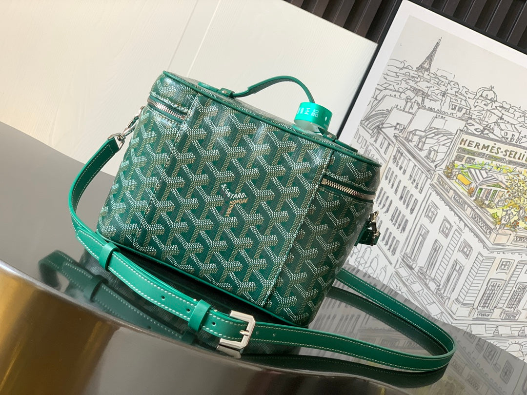 Green patterned small crossbody bag with long teal strap and top zip closure