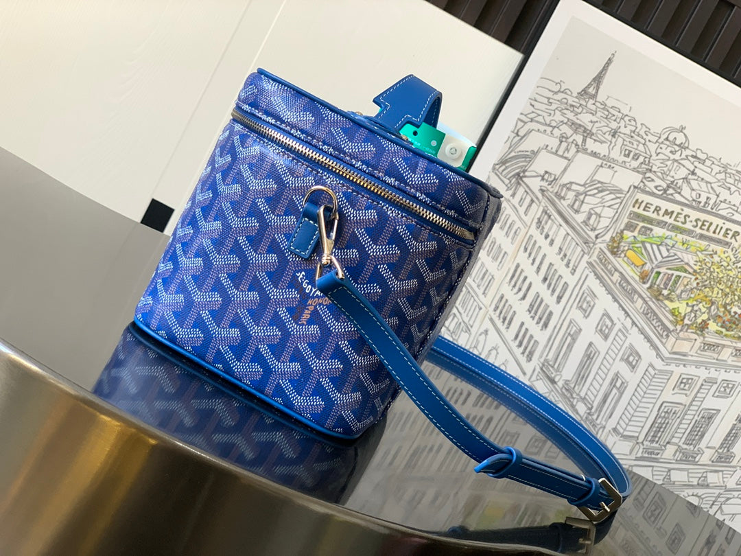 Blue patterned top-zip crossbody bag with short handle, long strap, gold zipper pull