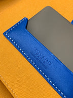 Blue leather strap detail with stamped Goyard text and orange base
