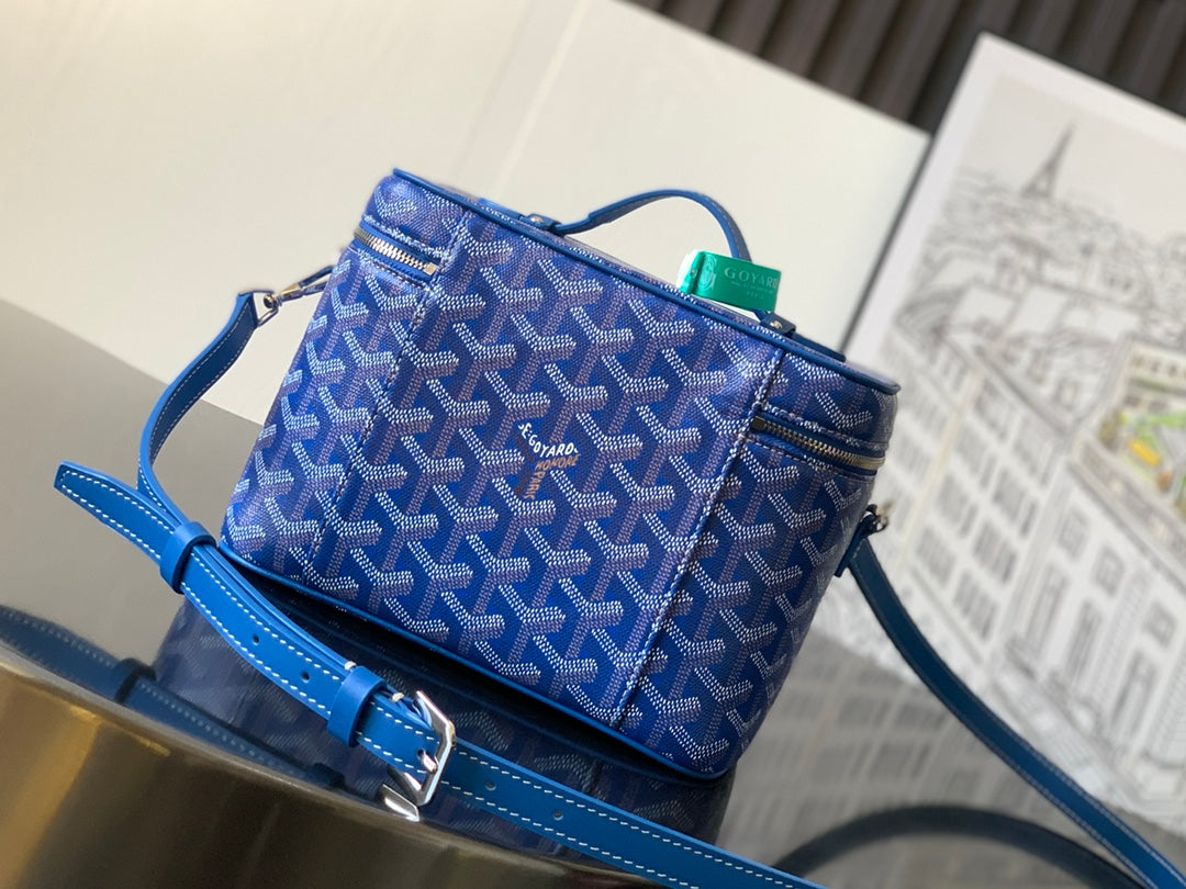 Blue patterned small bag with top handle and crossbody strap, silver hardware