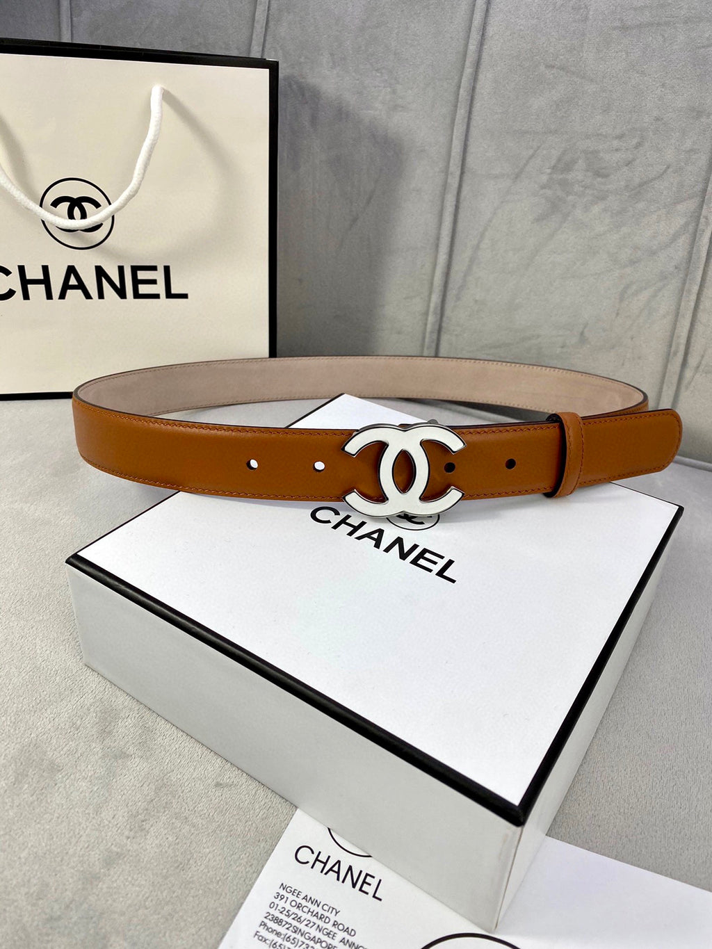 Chanel belt in tan leather with gold-tone CC buckle and single row of eyelets