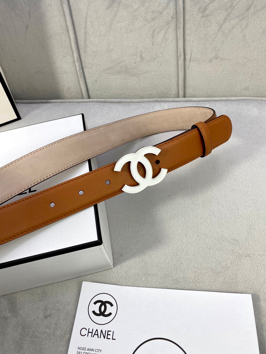 Chanel belt with tan leather strap and gold-tone CC buckle, front view
