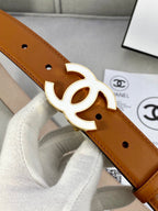Chanel belt close-up of tan leather strap with gold-tone CC buckle and punched holes