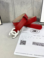 Red leather belt with gold-tone CC buckle beside receipt and product card