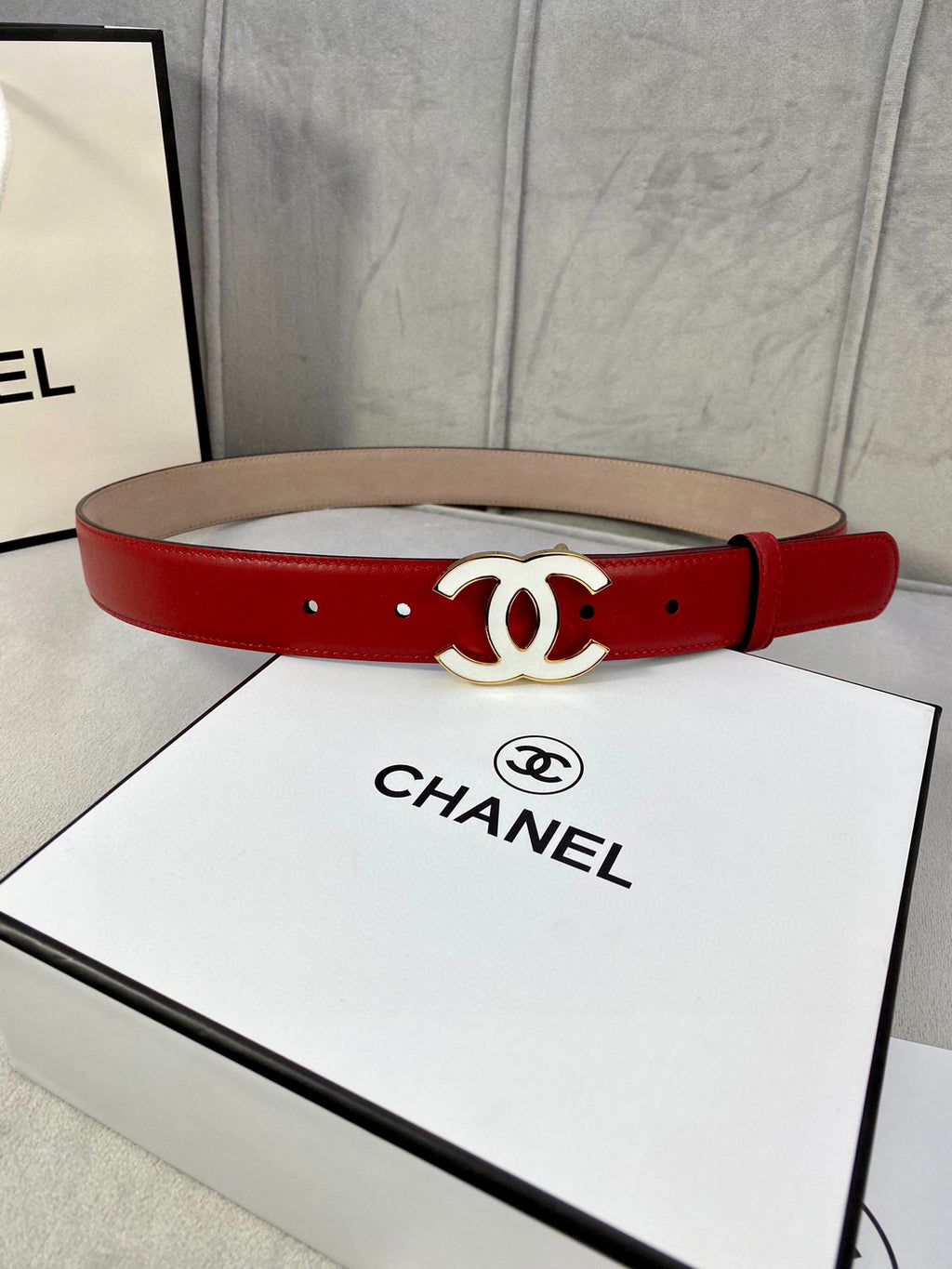 Red leather belt with gold-tone CC logo buckle and eyelet holes