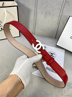 Red leather belt with gold-tone CC buckle over beige inner strap, held up