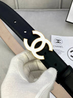 Black leather belt with gold CC buckle, close-up on buckle and hole details