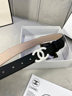 Black leather belt with gold CC buckle, resting in an open white box