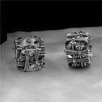 Pair of chrome rings with ornate floral cross and starburst detailing