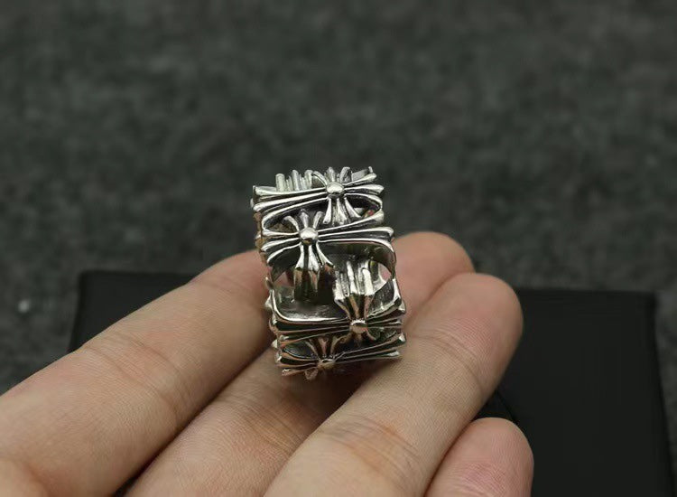 Chrome square ring viewed from front with raised floral cross centerpiece