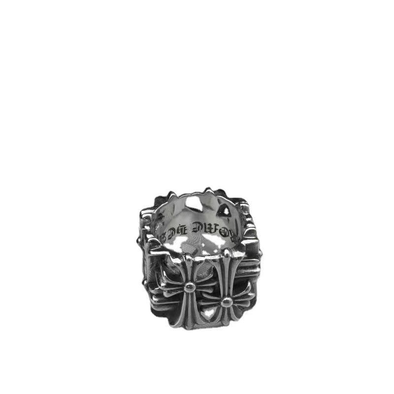 Chrome ornate ring with raised floral cross and diamond-like center