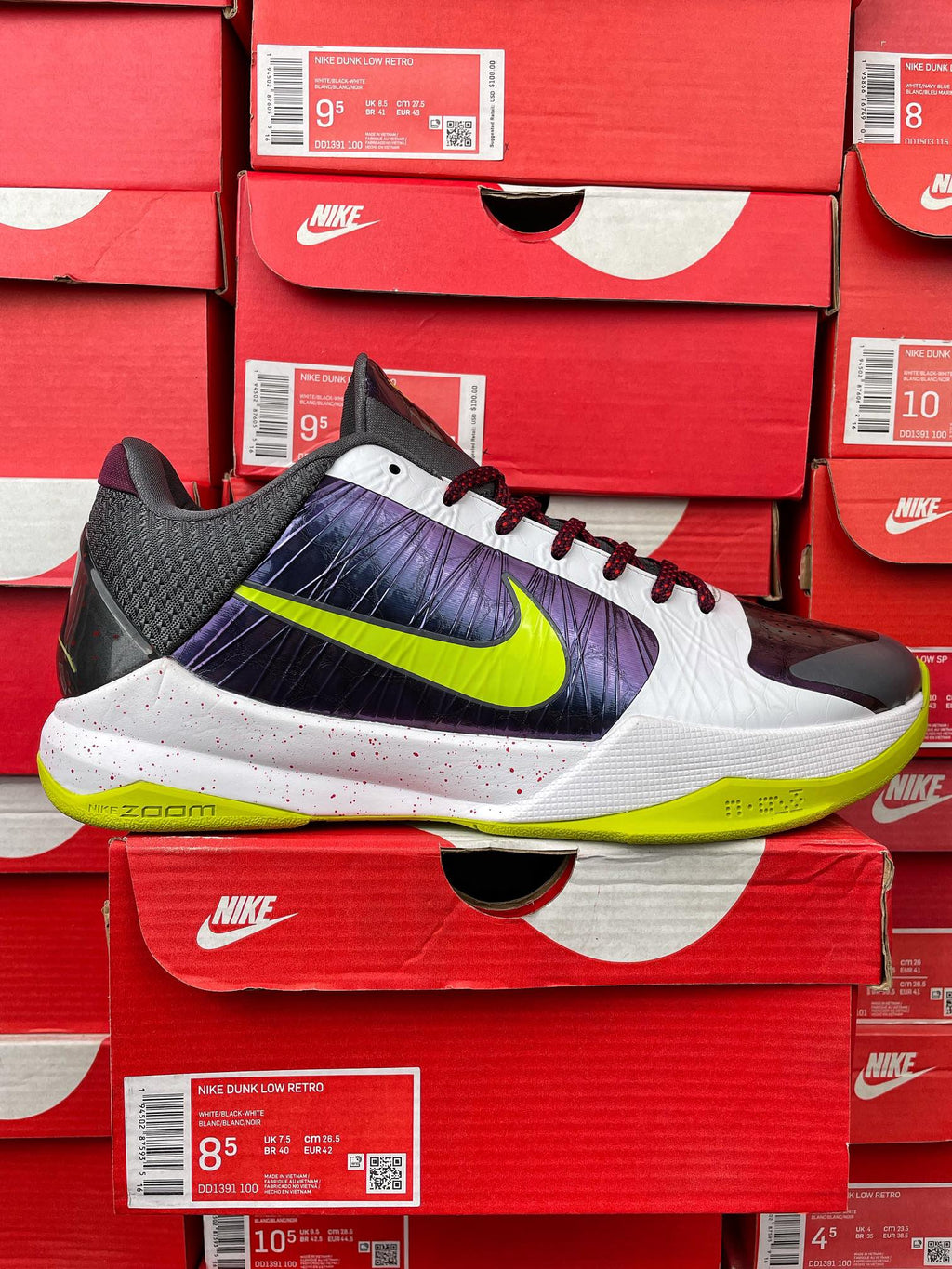 Low-top basketball shoe: white upper with purple panel and neon green swoosh