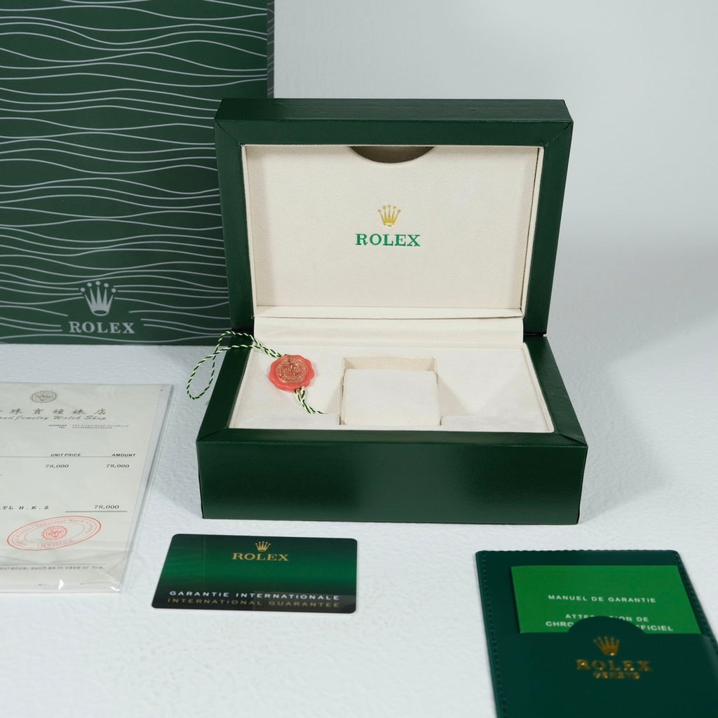 Rolex watch presentation box with papers and green branded inserts