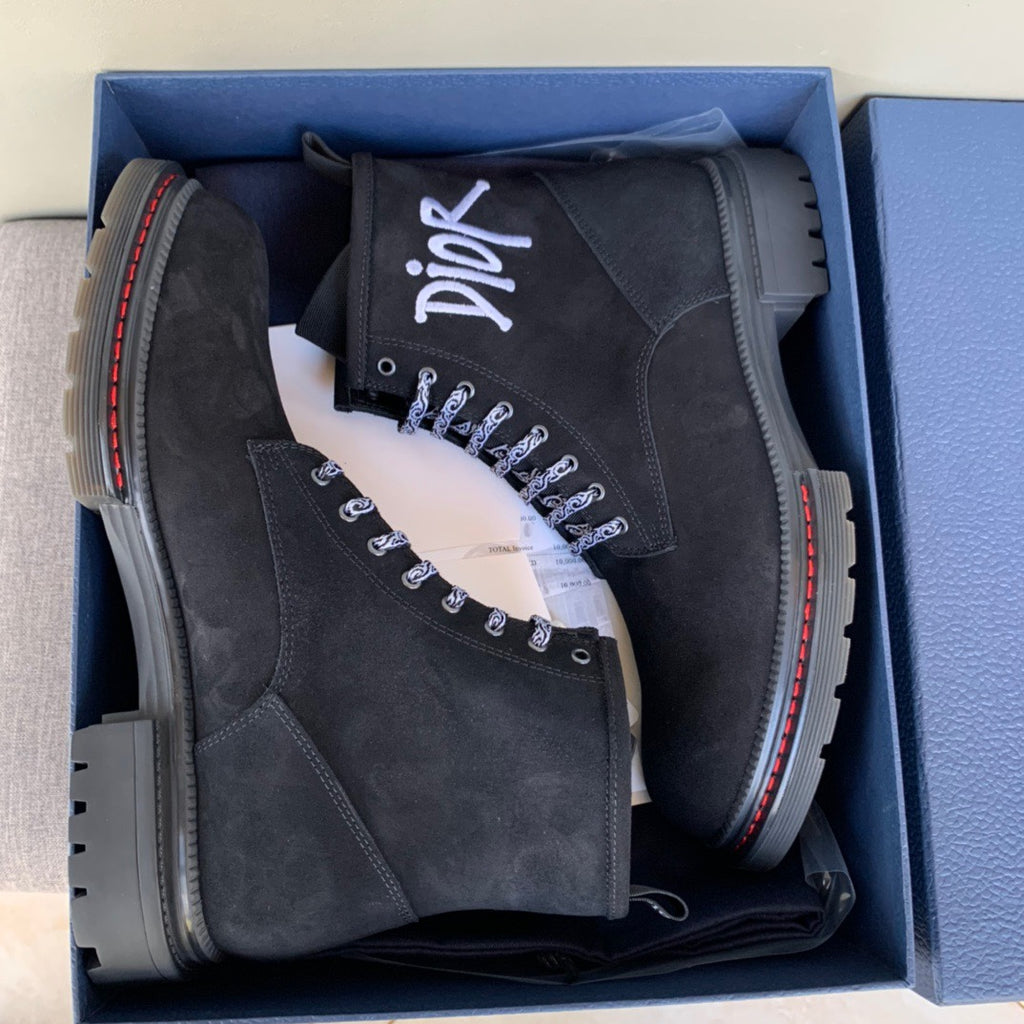 Pair of black suede lace-up ankle boots in a blue gift box, logos on tongue