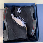 Pair of black suede lace-up ankle boots in a blue gift box, logos on tongue