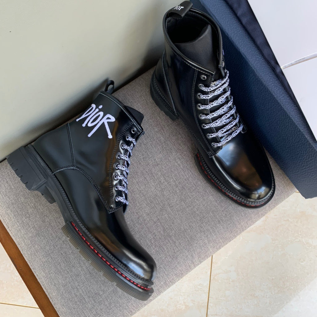Pair of black unisex leather ankle boots with lace-up front and Dior logo on the side