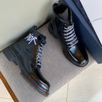 Pair of black unisex leather ankle boots with lace-up front and Dior logo on the side