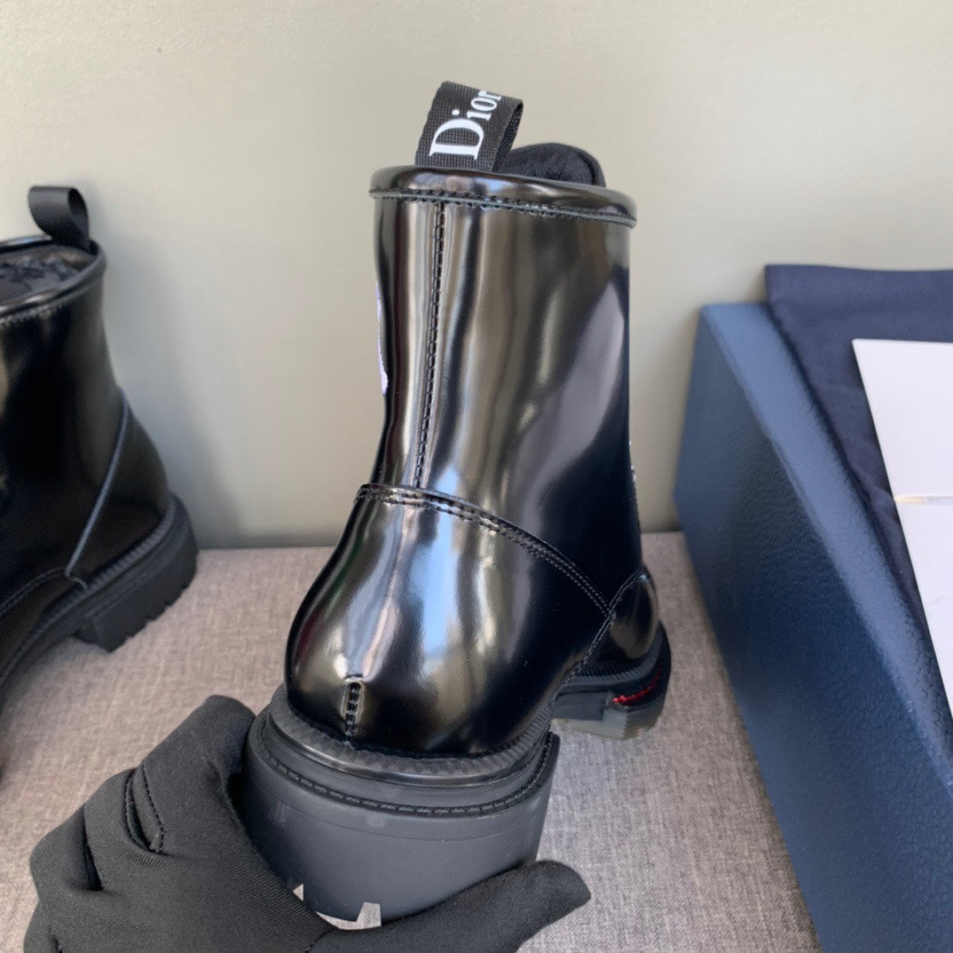 Black unisex leather ankle boot with Dior logo, heel tab, and platform lug sole