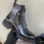 Black unisex leather ankle boot with lace-up front, Dior logo, and ridged lug sole
