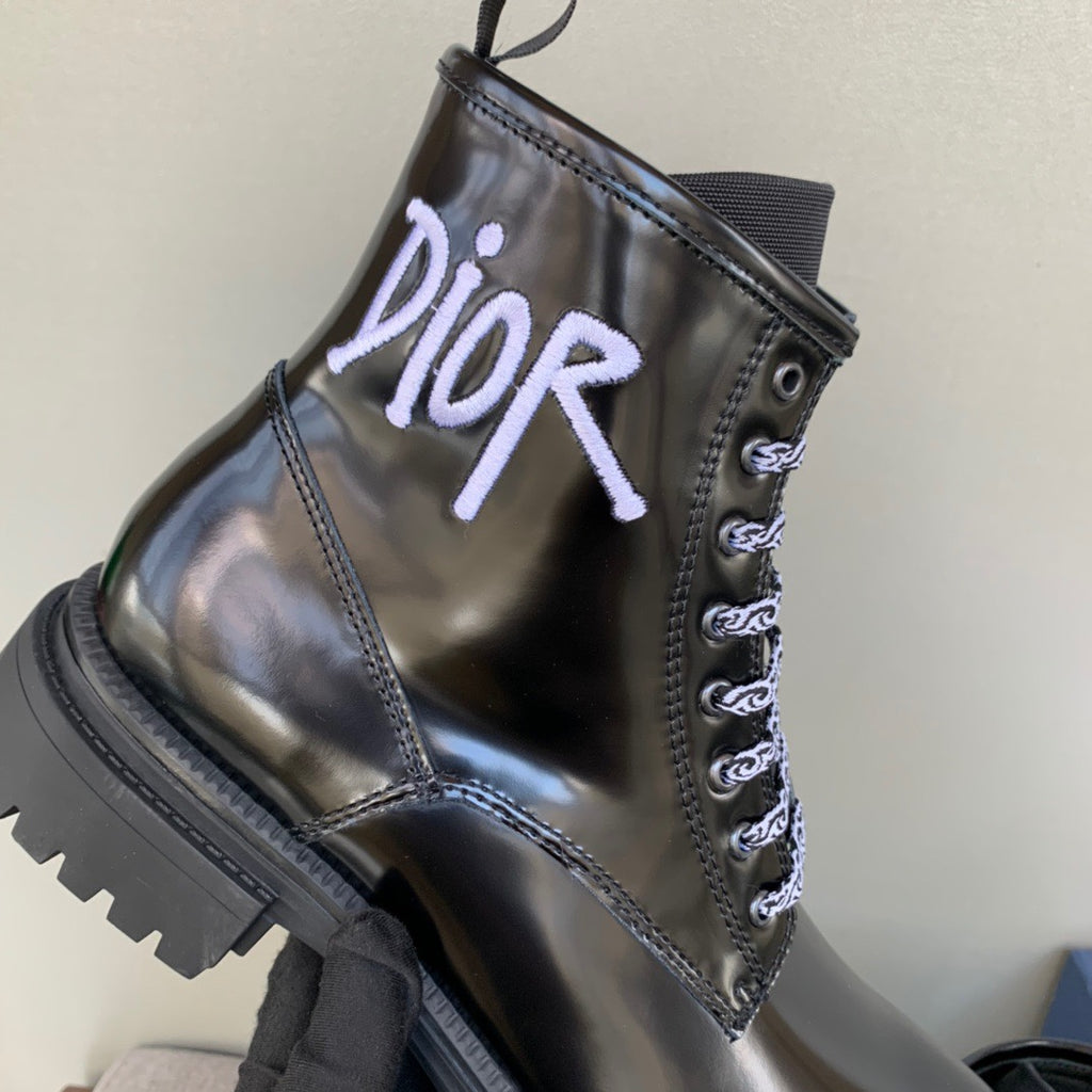 Black unisex leather ankle boot with lace-up design and Dior logo on the front