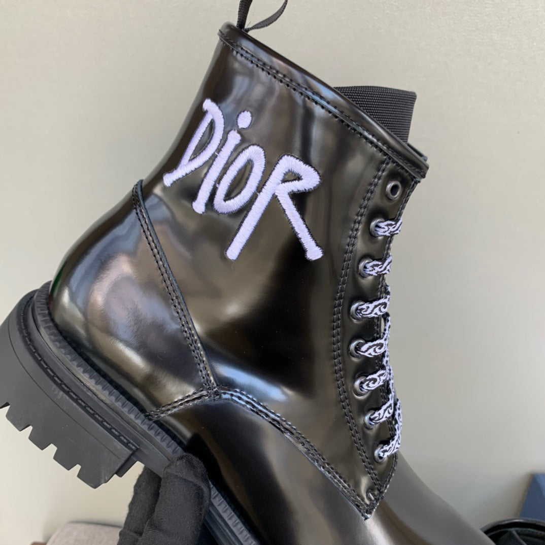 Black unisex leather ankle boot with lace-up design and Dior logo on the front