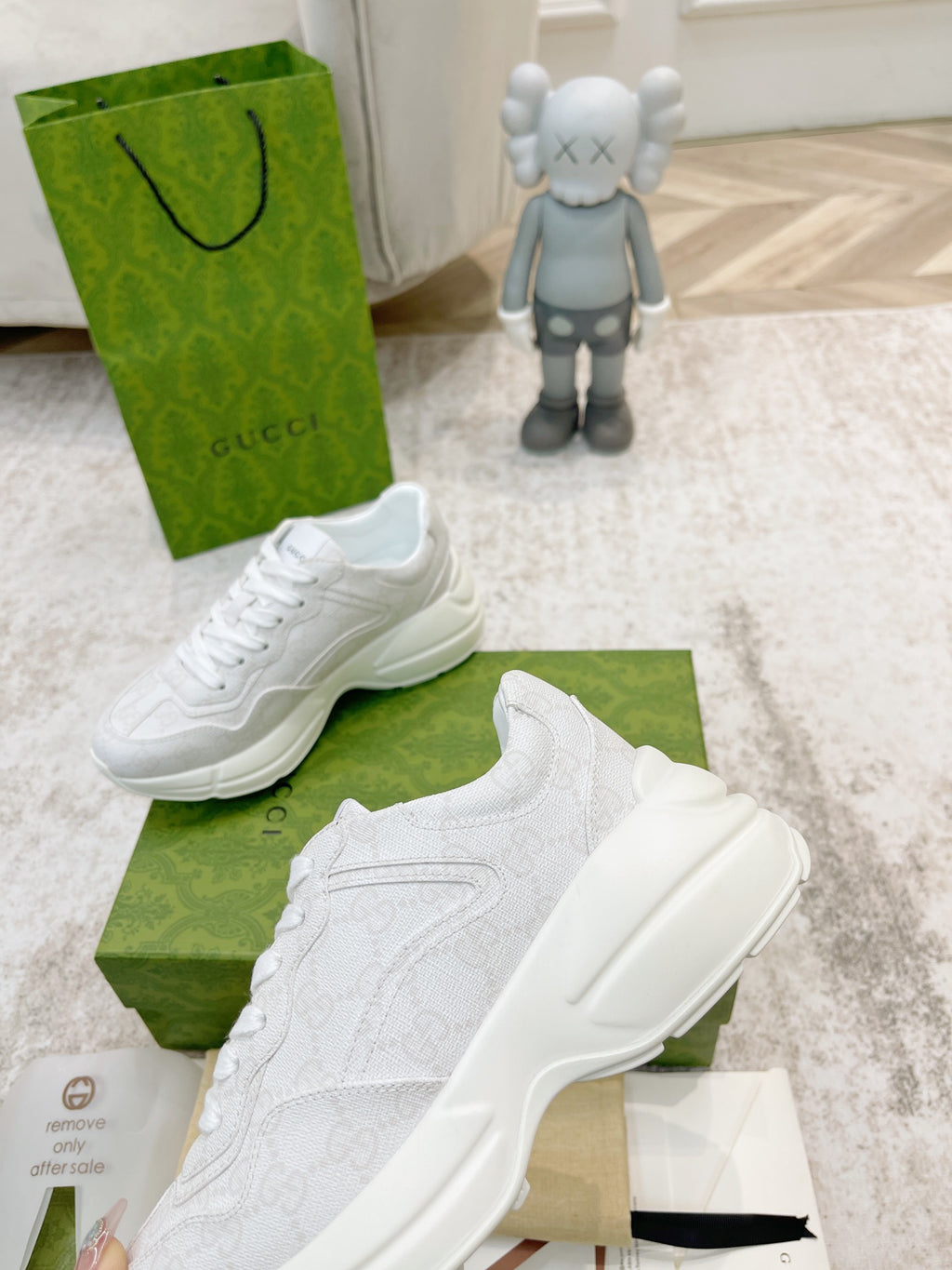 White Gucci lace-up sneakers angled on green box with heel and side detail