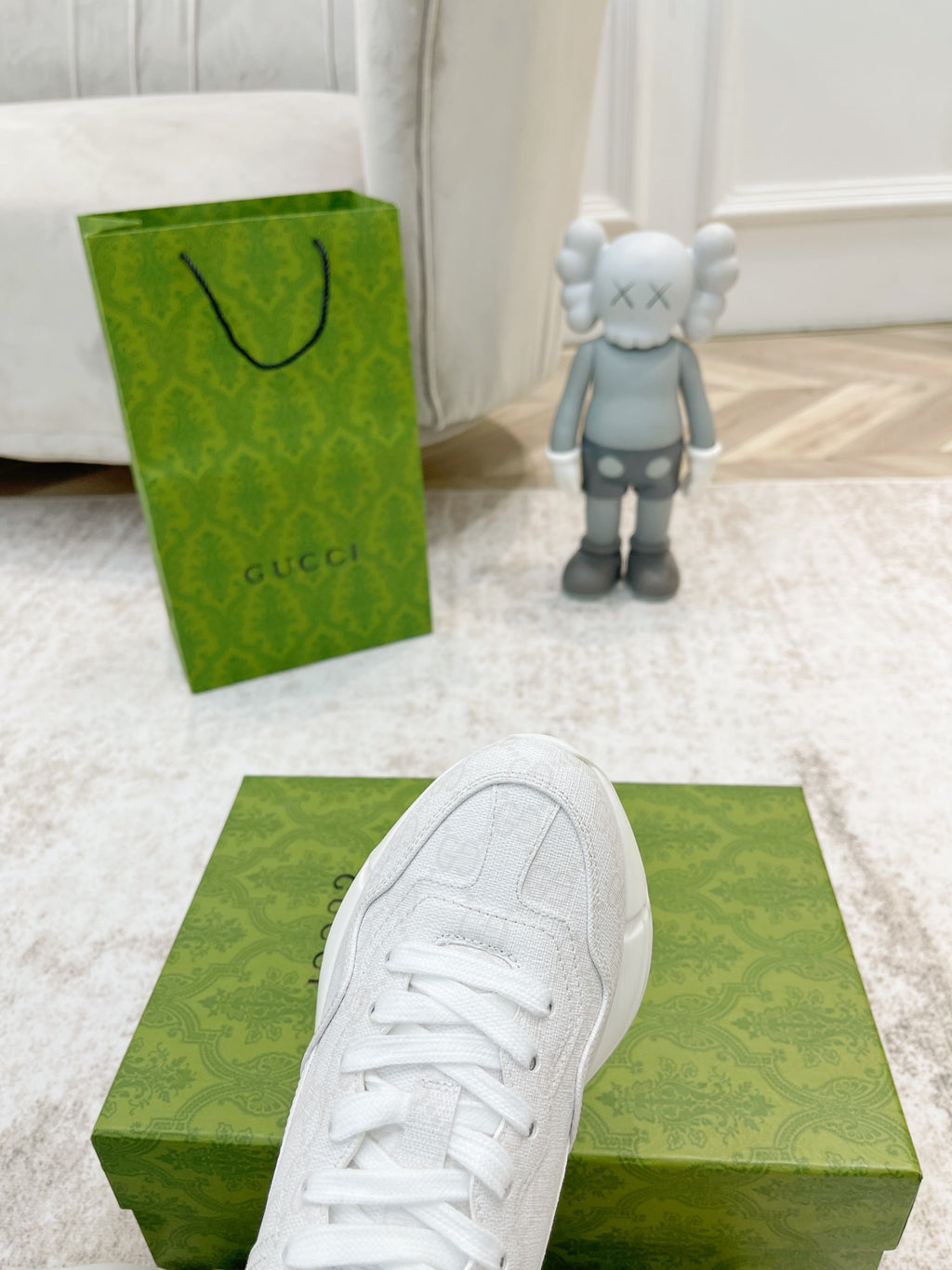 White Gucci sneaker toe and laces close-up on green box
