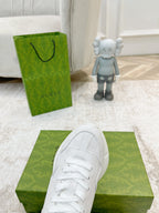 White Gucci sneaker toe and laces close-up on green box