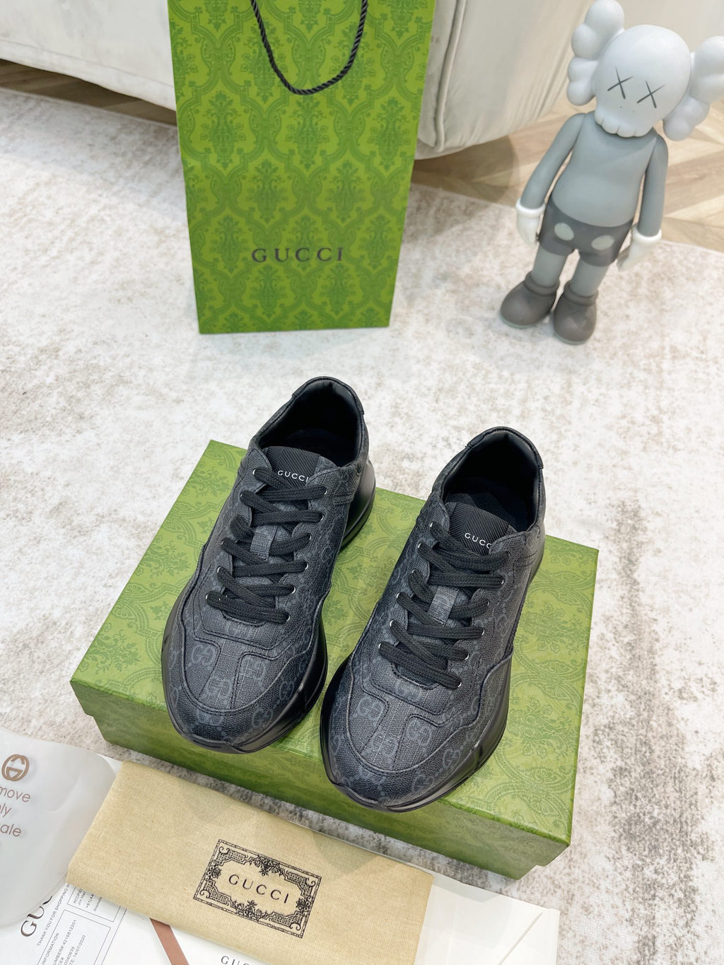 Gucci unisex lace-up sneakers, dark gray, shown as a front pair on a box