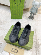 Gucci unisex lace-up sneakers, dark gray, shown as a front pair on a box