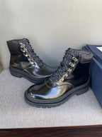 Black lace-up ankle boots with metal eyelets and textured lug sole