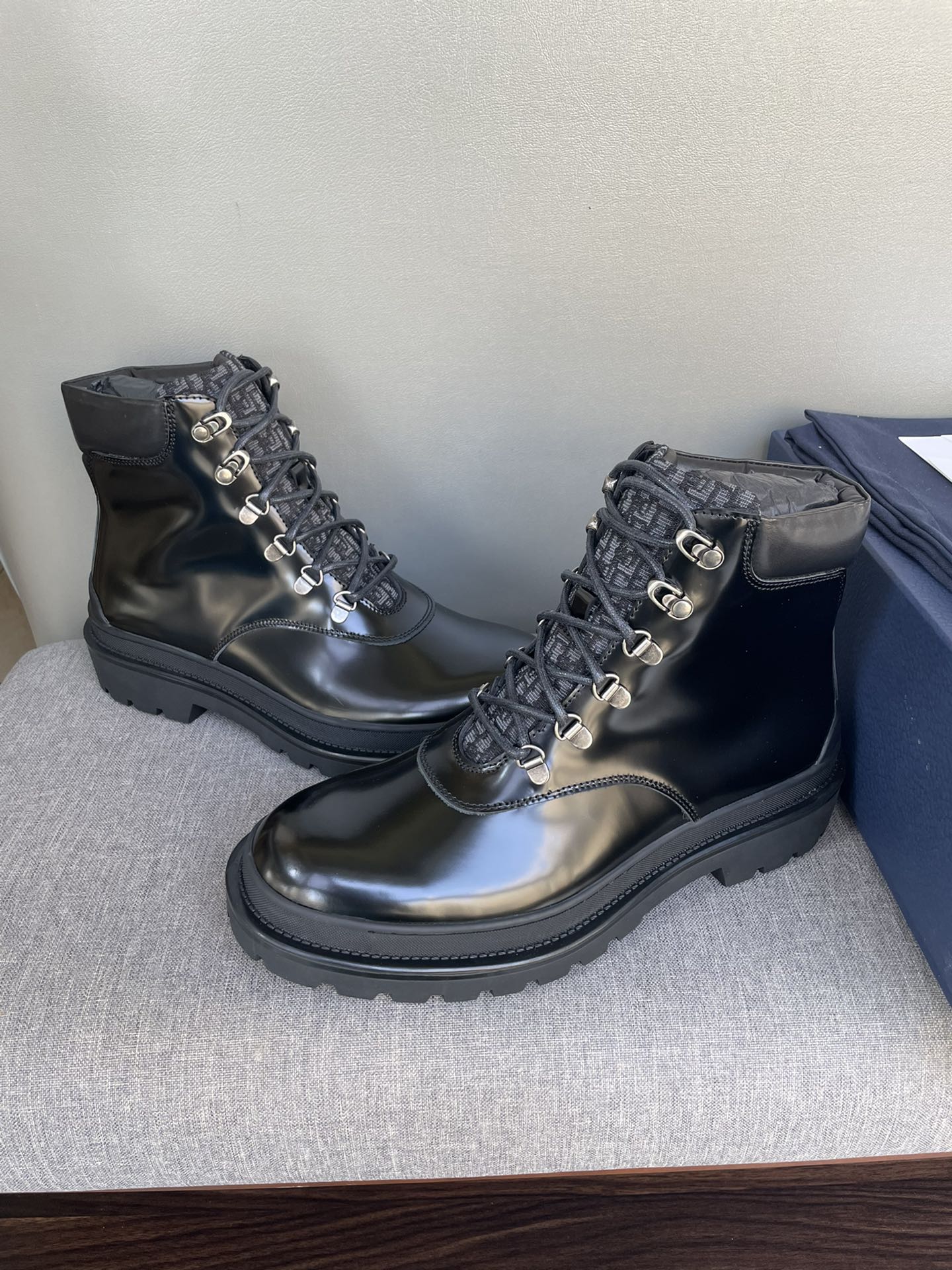 Black lace-up ankle boots with metal eyelets and textured lug sole