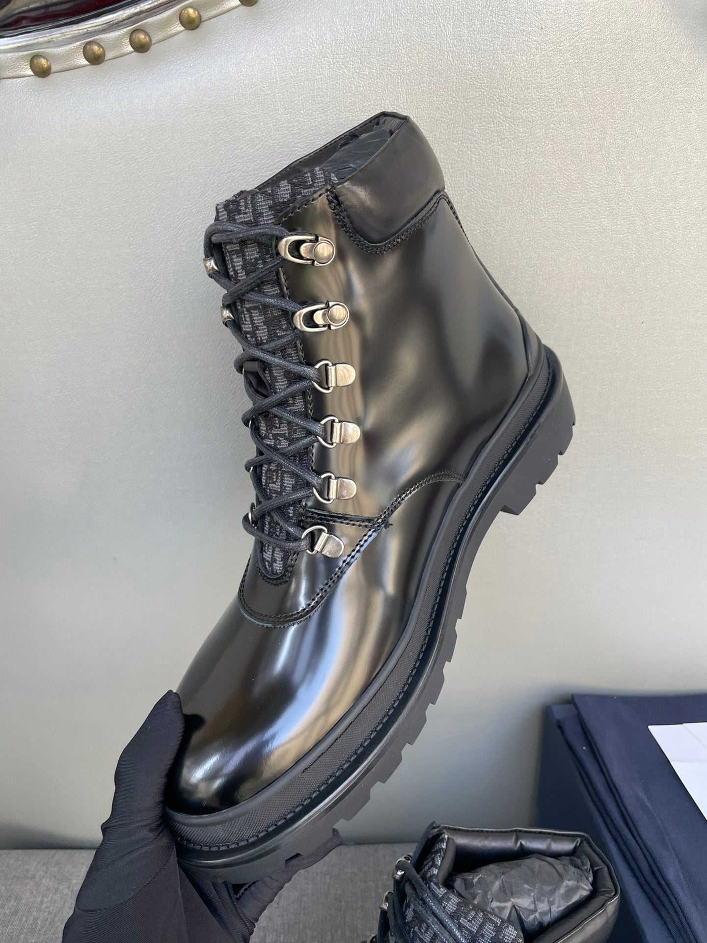 Black lace-up ankle boot with metal eyelets and pull-tab collar detail