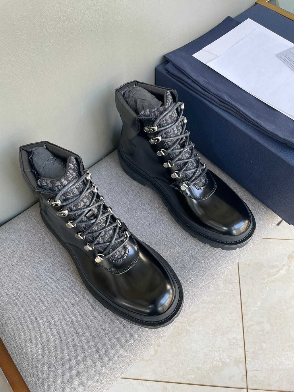 Black lace-up ankle boots with metal eyelets and chunky rubber sole