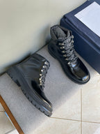 Dark lace-up ankle boots with metal eyelets and lug sole, pair on display