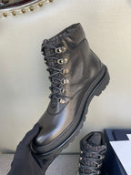 Dark leather lace-up boot with gold eyelets, stitched upper, thick rubber sole