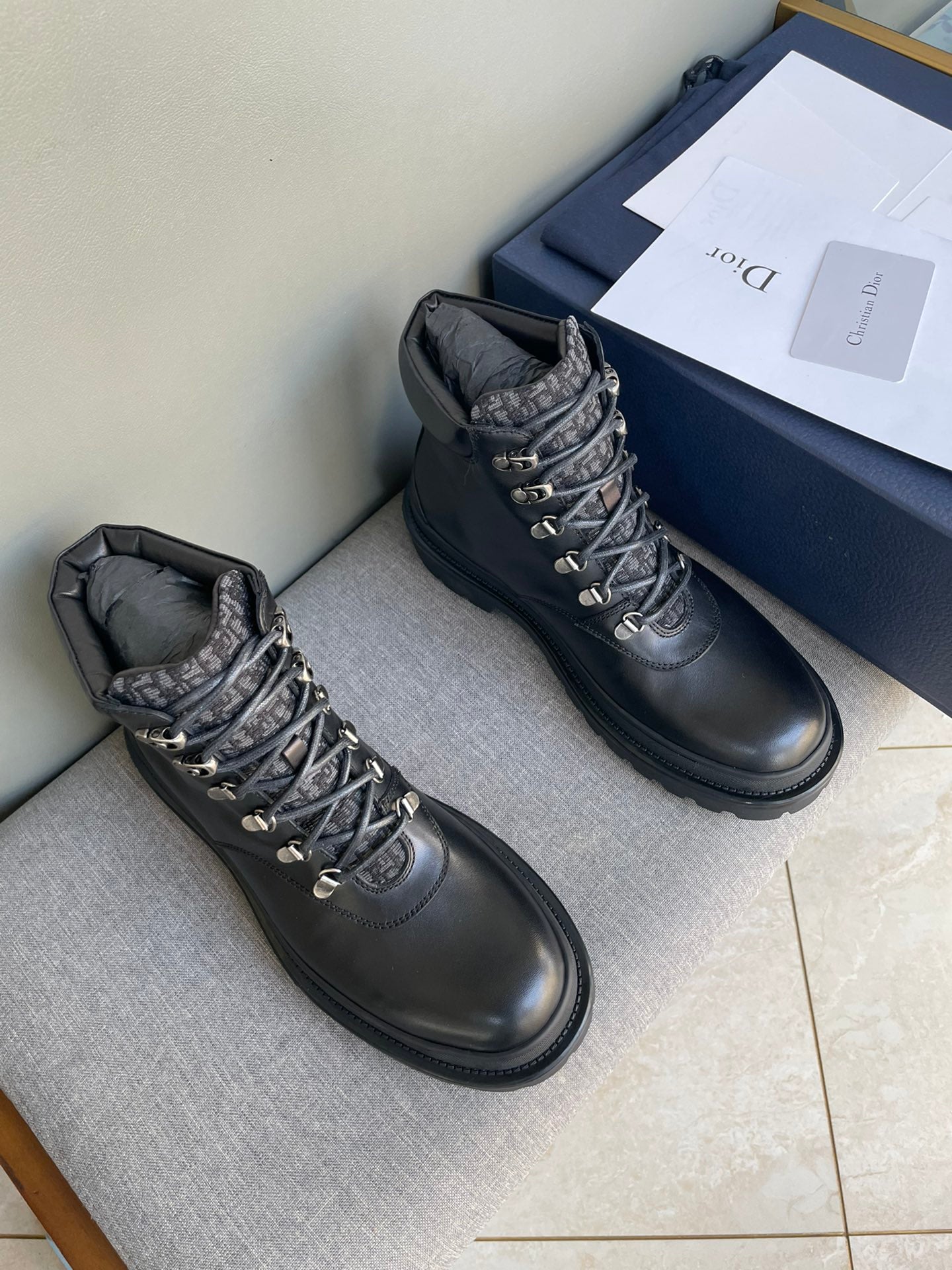 Lace-up Dior boots in dark leather, metal eyelets and chunky tread sole