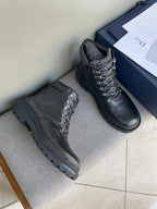 Pair of dark leather lace-up boots with gold eyelets and chunky rubber soles