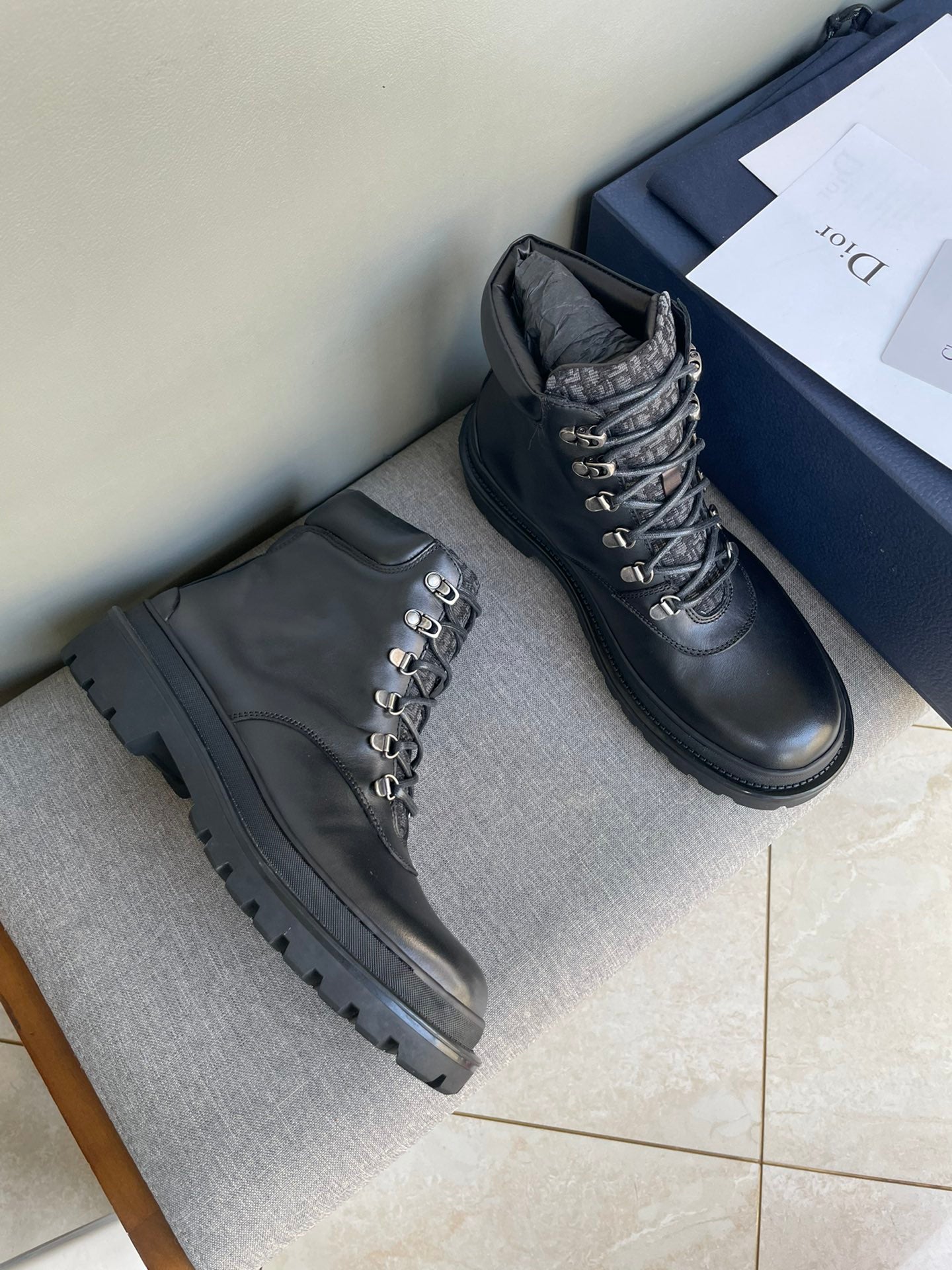 Pair of dark leather lace-up boots with gold eyelets and chunky rubber soles