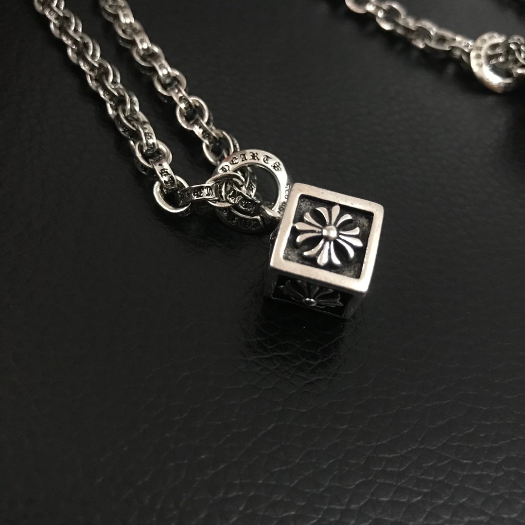 Silver-tone square charm pendant with flower-style detail on chain