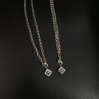 Silver-tone chain necklace with small square charm pendants