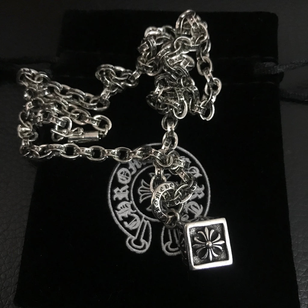 Silver-tone chain necklace with circular medallion and square pendant