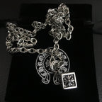 Silver-tone chain necklace with circular medallion and square pendant