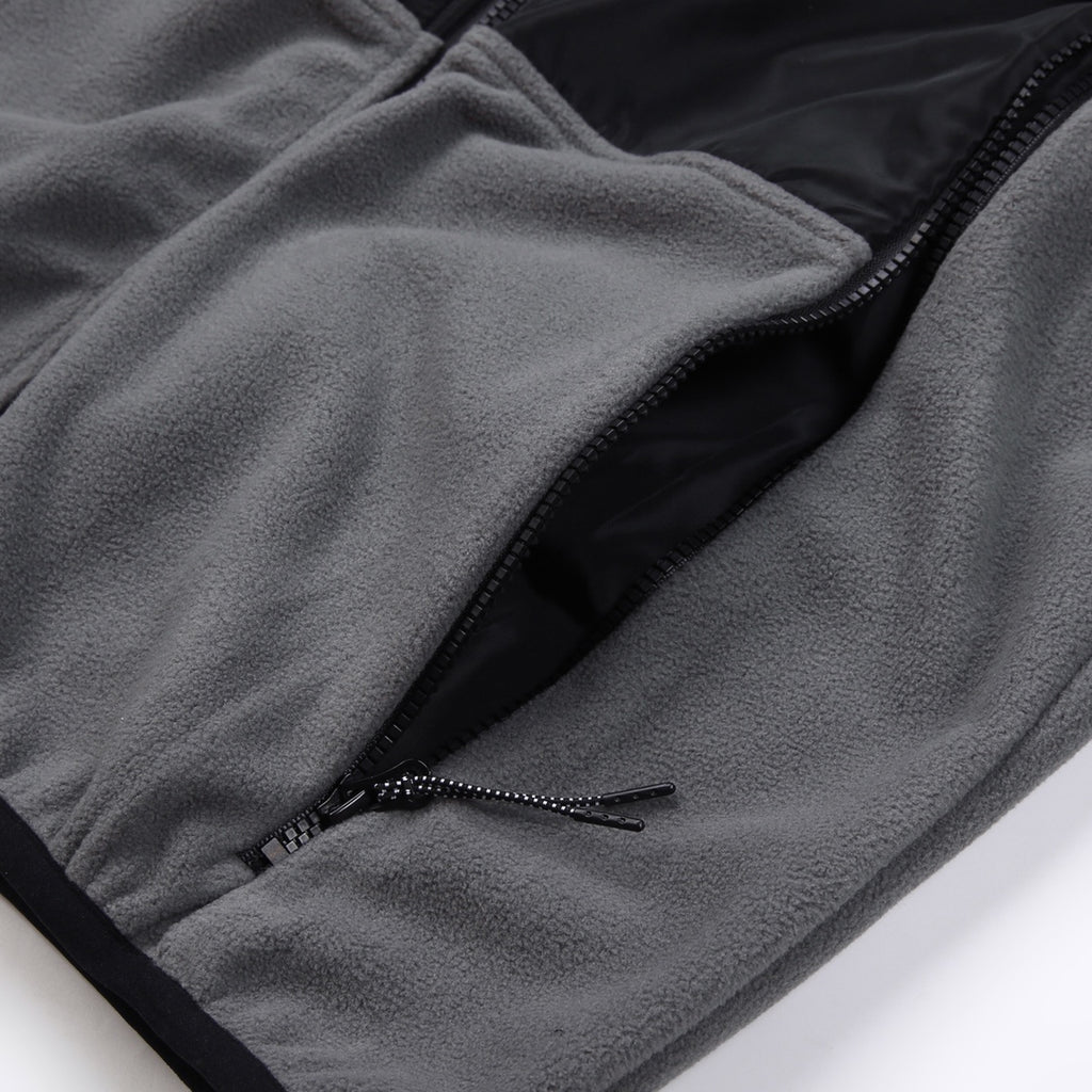 Stone Island jacket hem detail, gray fleece with black zipper and stitched pocket