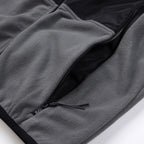 Stone Island jacket hem detail, gray fleece with black zipper and stitched pocket