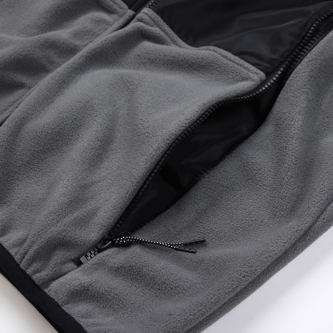 Stone Island jacket hem detail, gray fleece with black zipper and stitched pocket