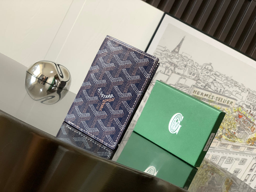 Small cardholder-style bag with dark navy patterned fabric and stitched edges
